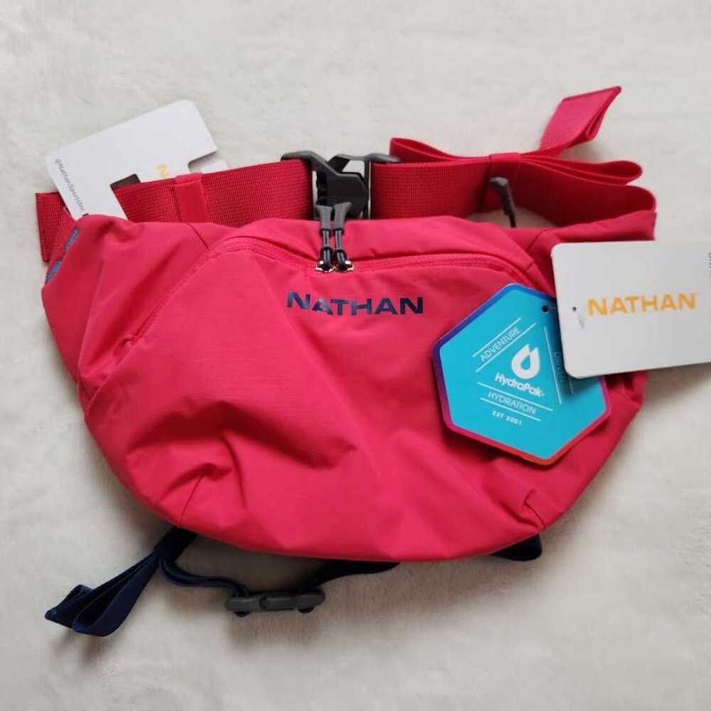 New Nathan women's Limitless Run 2L hydration sling bag in pink Raspberry